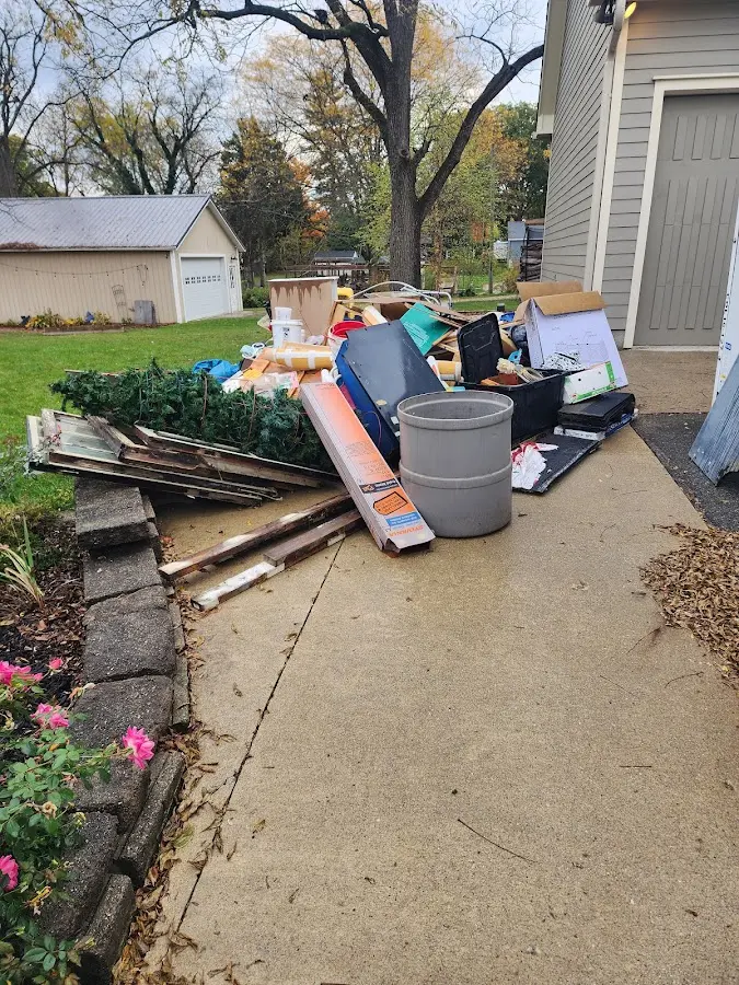 Dumpster being loaded with debris for 3 Yard Dumpster Rental in Dunlap